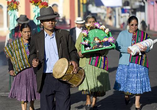 On their way to the catholic church the godmothers of the Pregon, carry the shrine through the streets of San Pedro Sacatepequez