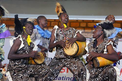 Youth performing Isukuti dance at a training session