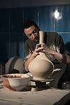Potter wheeler (Çarkçı) and craftsman of çini Ali Buzkan is shaping the clay