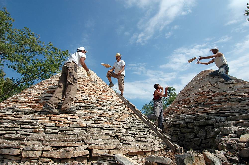 Rebuilding the roofs of the dry stone shelters during 'Moj kažun - La mia casita' community heritage campaign, which has been taking place around Vodnjan-Istria-Croatia every May since 2007. Restoration of numerous beloved local mini-landmarks by local stone professionals followed by educational and volunteering events