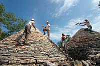 Rebuilding the roofs of the dry stone shelters during 'Moj kažun - La mia casita' community heritage campaign, which has been taking place around Vodnjan-Istria-Croatia every May since 2007. Restoration of numerous beloved local mini-landmarks by local stone professionals followed by educational and volunteering events