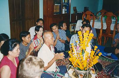 A family holds a Baci Su Kwan ceremony in Laos.