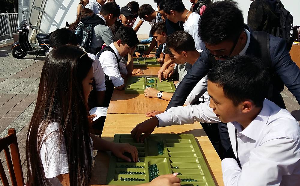 School children playing Togyzqumalaq during open air masterclasses in the center of Almaty (Kazakhstan)