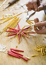 Handmade production of Christmas tree decorations from blown glass beads