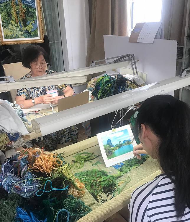 A master and apprentice practice cashmere embroidery at the Shanghai Museum of Arts and Crafts