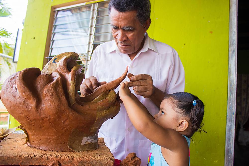 Darío López, a mud mask artisan, works together with his granddaughter. Parita, Herrera