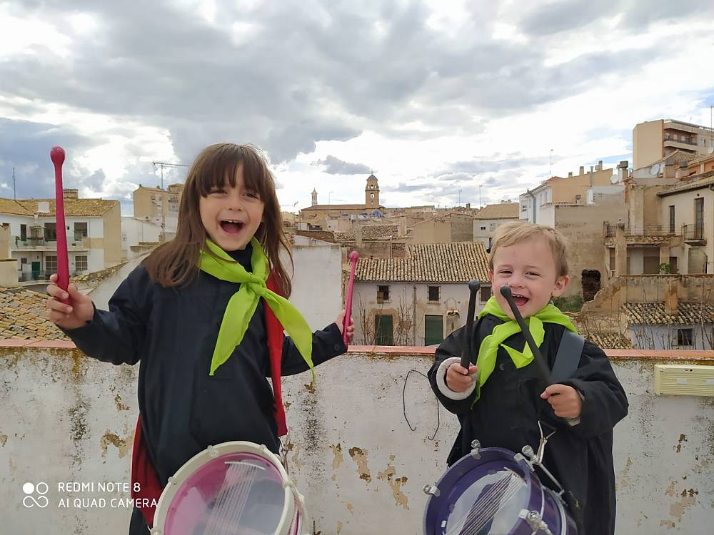 Enara and Fran beat drums from rooftops as part of tamboradas celebrations in Hellin, Spain, April 2020, which took place from homes this year rather than on the streets.
