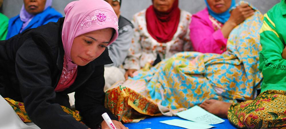 In Yogyakarta, Indonesia, women at a community meeting discuss the reconstruction of their village in the wake of the 2006 tsunami and earthquake.