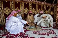 A group of men gathered in a festive occasion eating the popular harees dish (United Arab Emirates)
