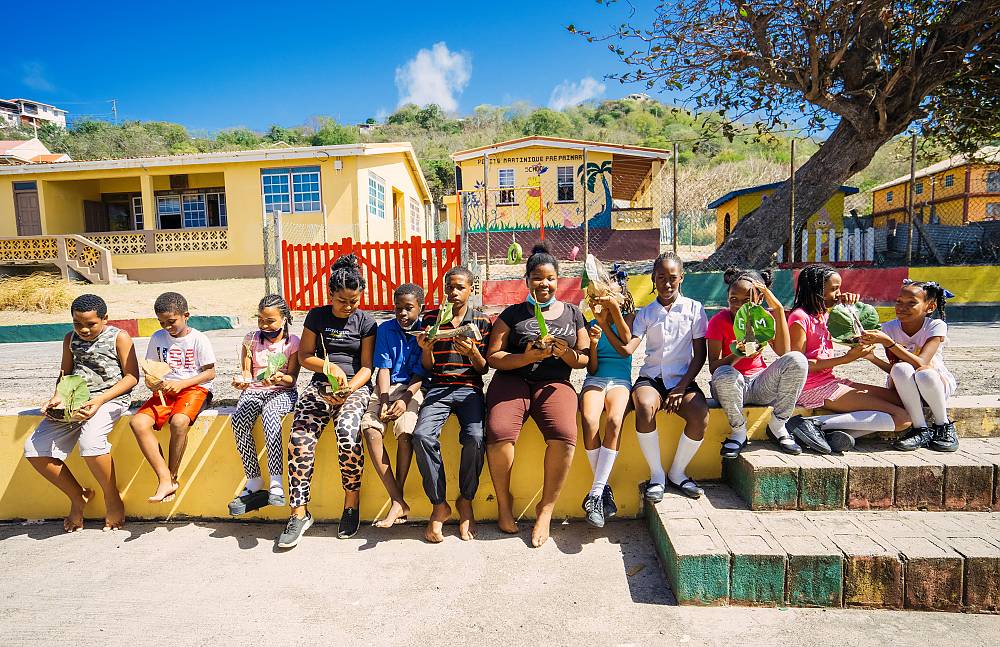The 2021 grade students of the Petite Martinique Roman Catholic School after an exercise in designing and creating their own coconut shell and grape leaf boat