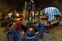 Glass blowing in a wooden mould with a team of glassmakers in a building a former glass works (1826), Germany