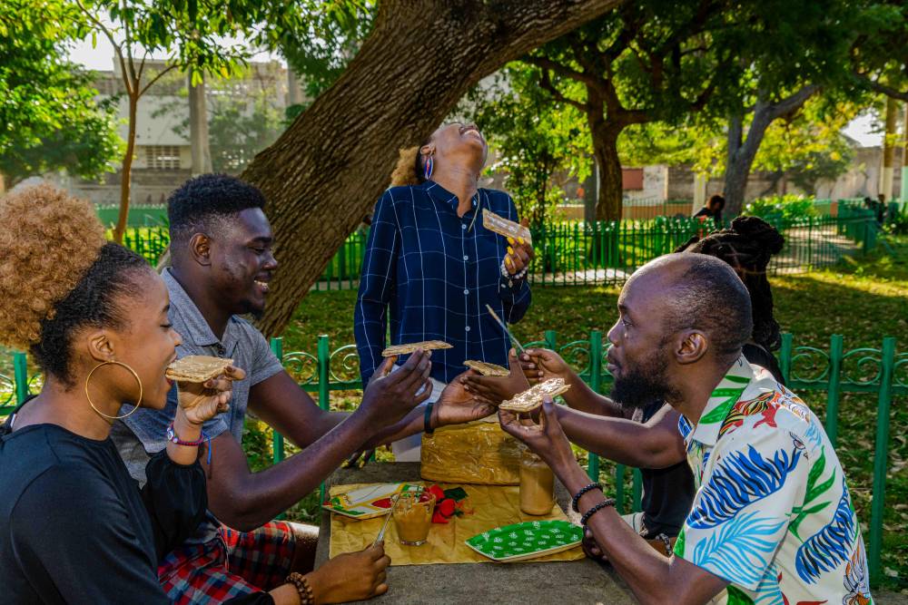Young Haitians enjoying kasav during lunch break