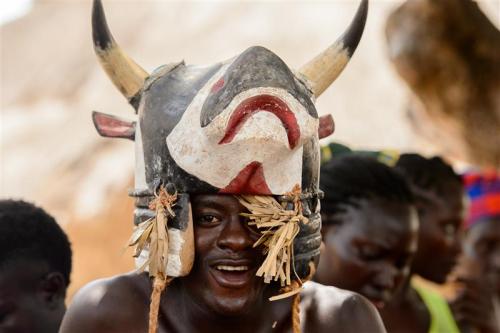 ORANGO ISL., GUINEA BISSAU - MAY 3, 2017: Unidentified local A man in a cow mask smales during Vaca Bruto, traditional Mask dance /
